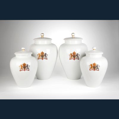 A rare four piece white garniture with a coat of arms of double-headed eagle