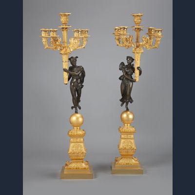 A stunning pair of French Empire gilt and patinated bronze five-light candelabra