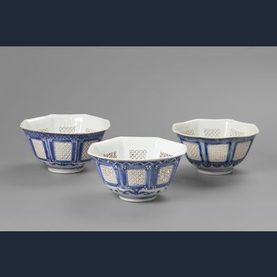 A set of three matching octagonal reticulated blue and white bowls