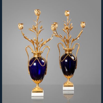 An elegant pair of French Louis Seize ormolu mounted midnight blue glass three-light vase candelabra