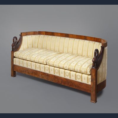 A mahogany Empire sofa with carved swans