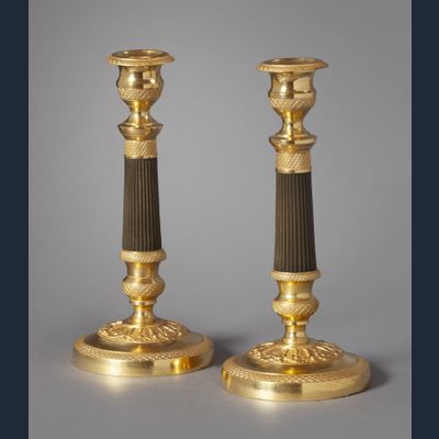 A pair of ormolu and bronze Charles Dix candlesticks