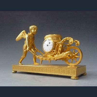 Attractive small mantel clock / pendulette, Amor  with wheelbarrow, Austria circa 1810.
