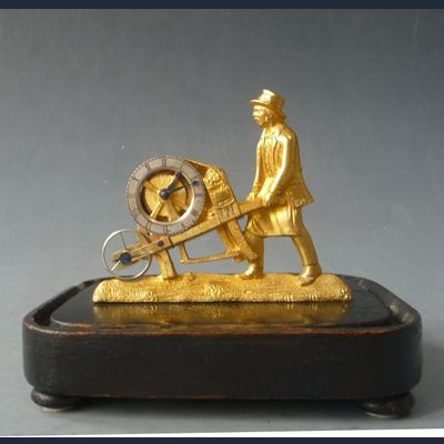 Austrian pendulette, bronze sculpture, man with wheelbarrow, Vienna circa 1840.