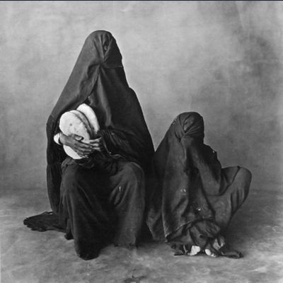 Two women, wearing black, with bread, Morocco 1971
