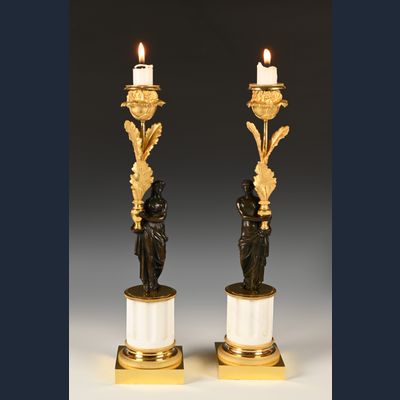 A pair of ormolu and patinated bronze candlesticks