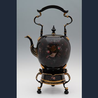 A  pewter bouilloire on a stand