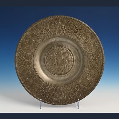 A pewter relief plate