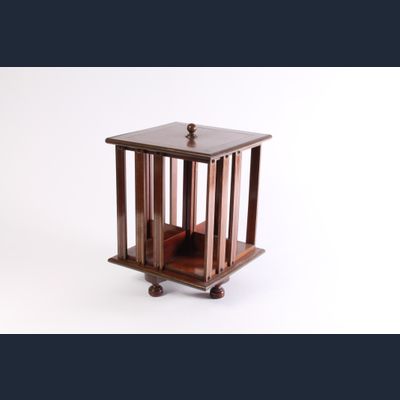 A small English brass inlaid mahogany revolving bookcase, circa 1880.