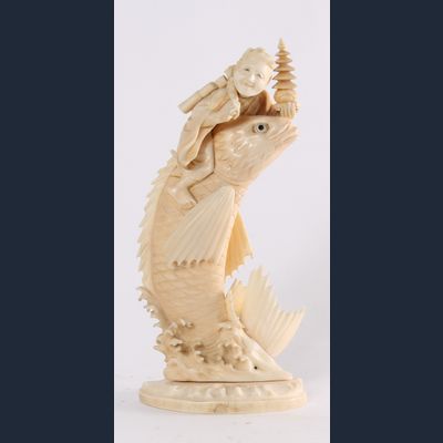 'Man on a Carp', a Japanese carved ivory sculpture, circa 1880