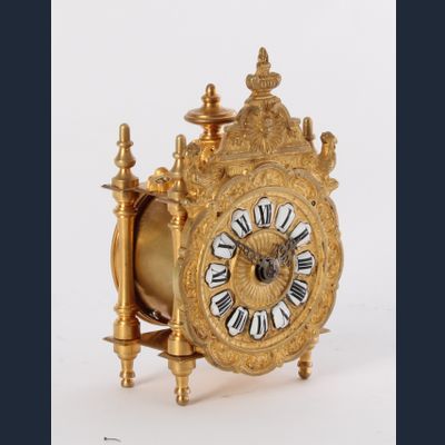 A miniature French Regence-style gilt brass table timepiece, circa 1870.