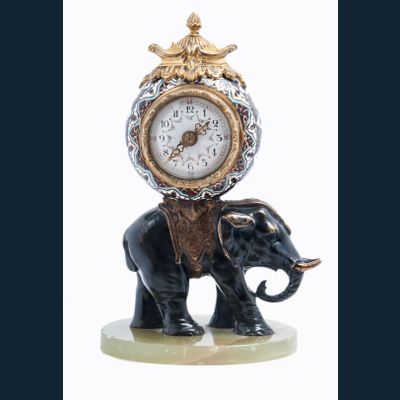 Cute miniature time piece pendulum of a bronze elephant carrying the movement 