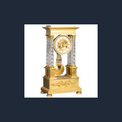 An attractive Charles X ormolu and crystal portico striking 8-day mantel clock
