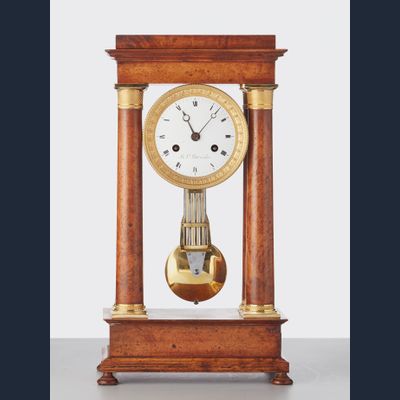 A French ‘Empire’ maple and gilt 4-column clock, circa 1830