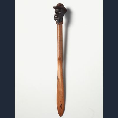 An American coloured wood ‘dandy face’ letter opener, circa 1880