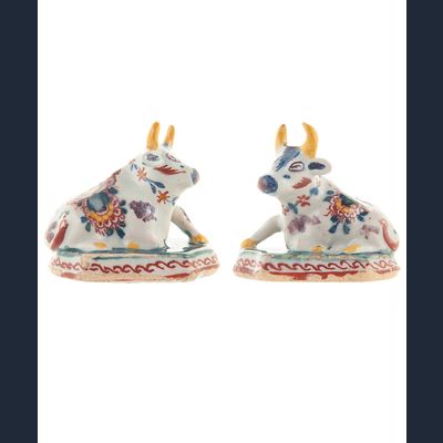 Pair of Miniature Dutch Delft Polychrome Figures of Recumbent Cows