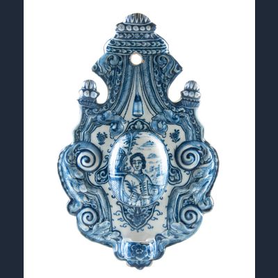 A Blue and White Dutch Delft Earthenware Sconce Decorated with a Figure