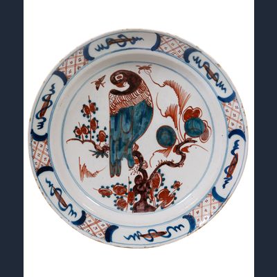 A Polychrome Dutch Delft Charger Depicting a Parrot