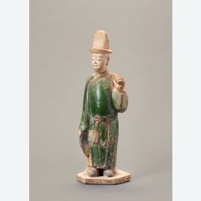 A Chinese green-glazed pottery figure of a tomb attendant