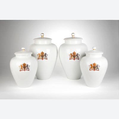 A rare four piece white garniture with a coat of arms of double-headed eagle