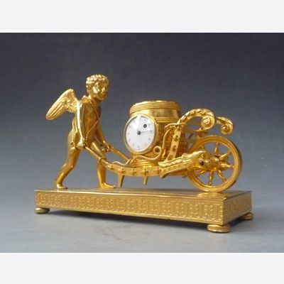Attractive small mantel clock / pendulette, Amor  with wheelbarrow, Austria circa 1810.
