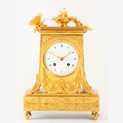 A lovely French Empire ormolu borne mantel clock with butterfly, circa 1800