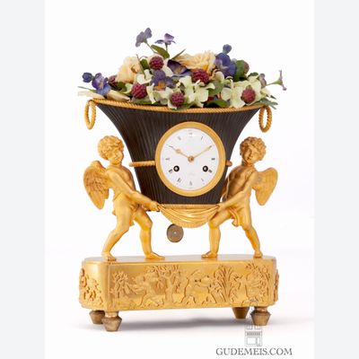A French Empire ormolu and bronze mantel clock, putti with flower urn, circa 1800