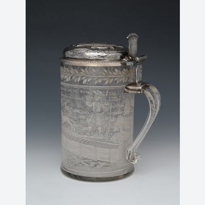 An enamelled glass jug with a silver lid