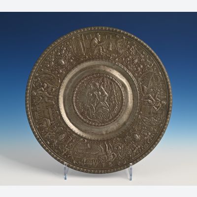 A pewter relief plate