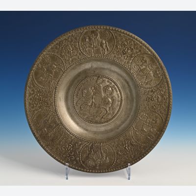 A pewter relief plate