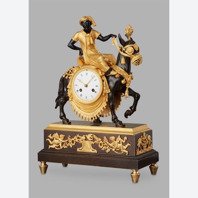 An unusual French ‘Directoire' gilt and patinated bronze mantel clock with young Arab on mule, circa 1800
