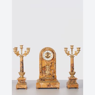 A French sienna marble clock with candle holders, circa 1890