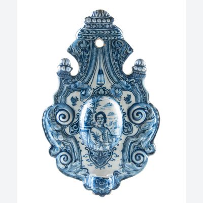 A Blue and White Dutch Delft Earthenware Sconce Decorated with a Figure