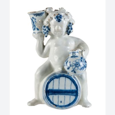 A Blue and White Dutch Delft Bacchus on Wine Barrel