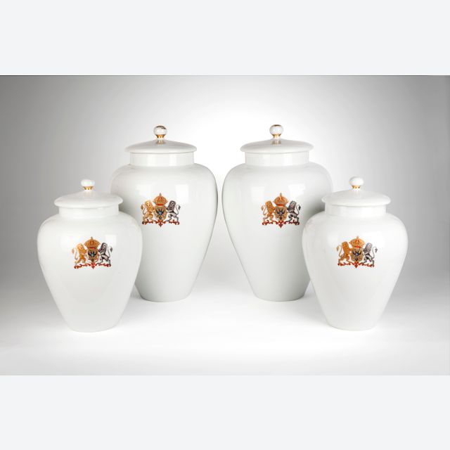 A rare four piece white garniture with a coat of arms of double-headed eagle
