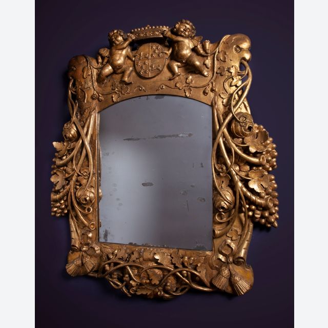 A Louis Quartorze mirror with a coat of arms of VOC governor Cornelis Kien