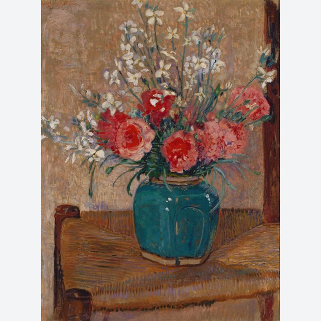 Flowers in a pot on a cane chair