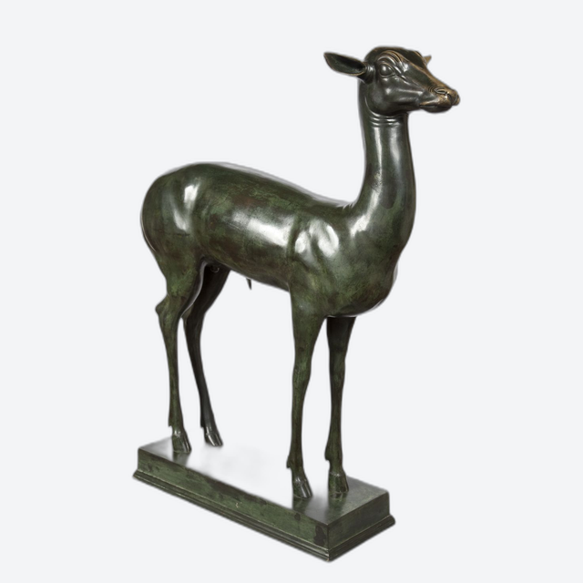 An elegant bronze sculpture of a fawn