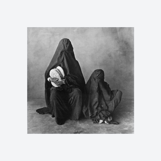 Two women, wearing black, with bread, Morocco 1971