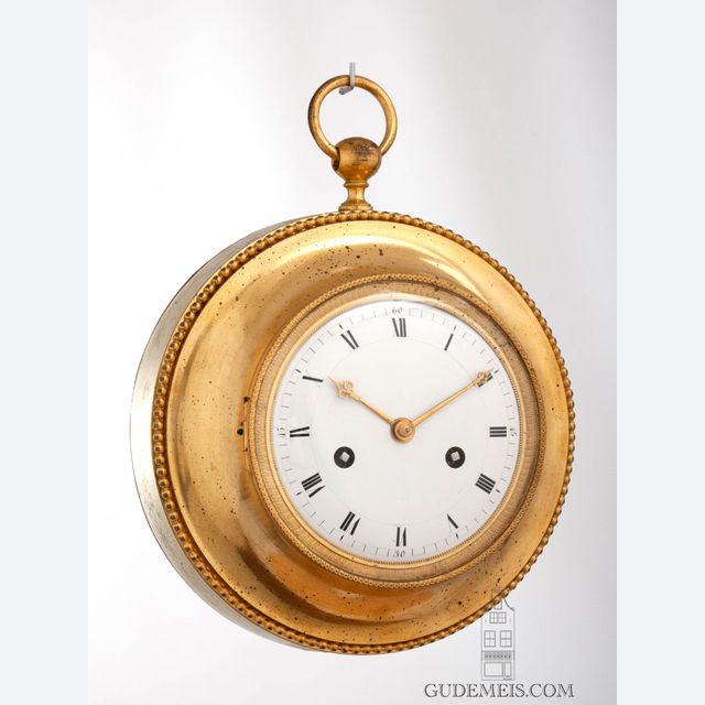 A French Empire ormolu annular striking cartel wall clock, circa 1800.