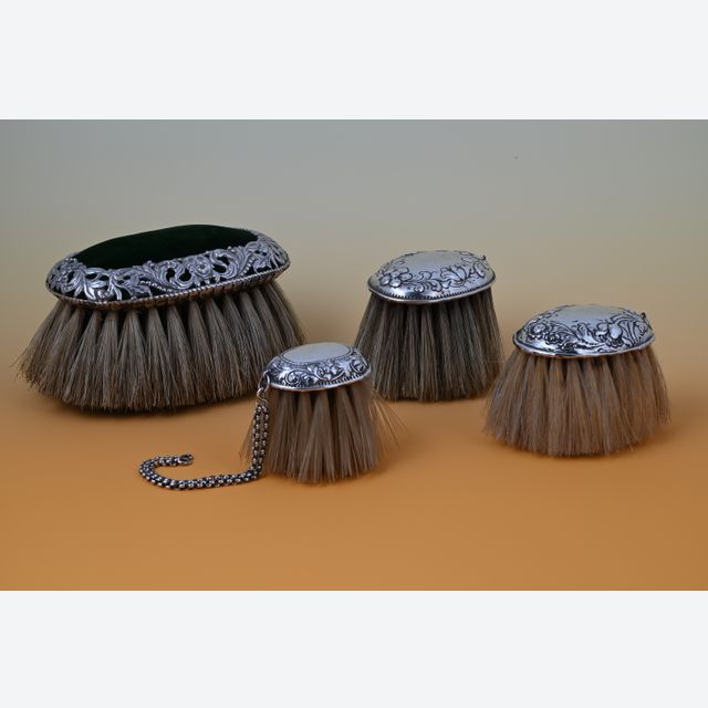 Four brushes, silver mounted. 1500,- for the set