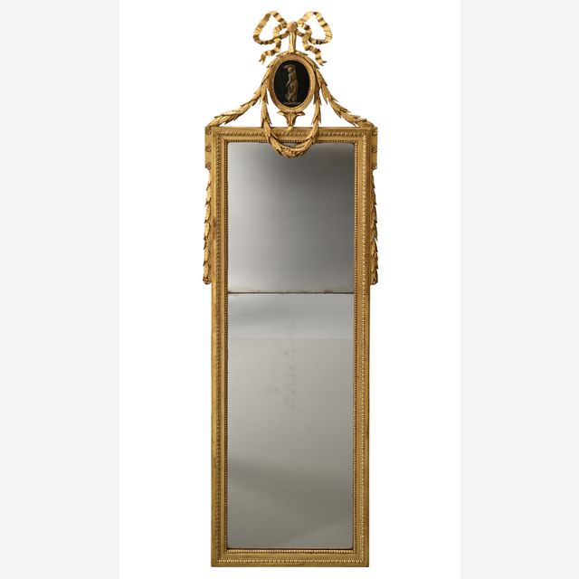 A Louis XVI mirror with a medallion