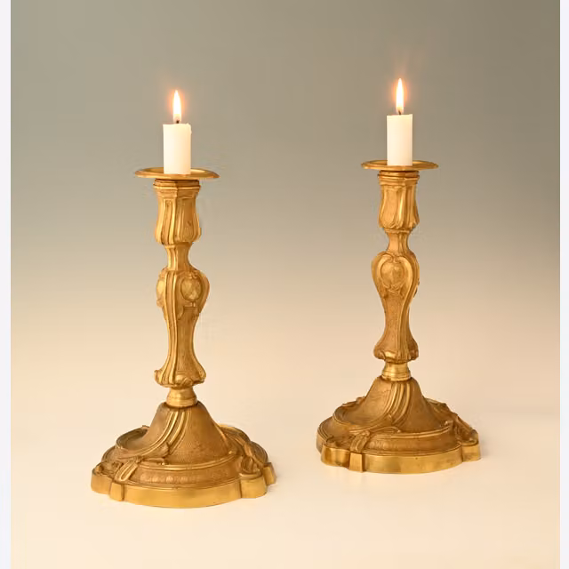 A pair of large fire-gilded bronze candlesticks in the Louis XV style.
