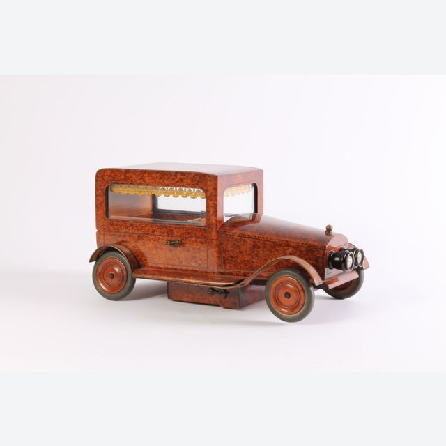 An Art Deco thuja burr model of a car with music box, circa 1930