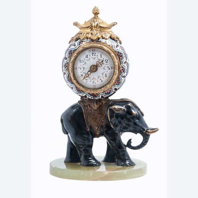 Cute miniature time piece pendulum of a bronze elephant carrying the movement