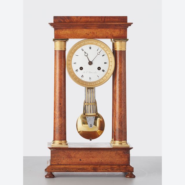 A French ‘Empire’ maple and gilt 4-column clock, circa 1830