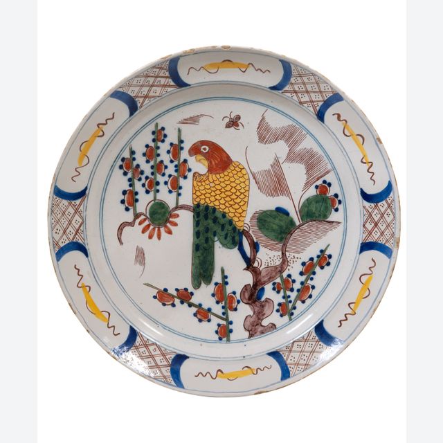 A Polychrome Dutch Delft Charger Depicting a Parrot