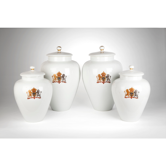 A rare four piece white garniture with a coat of arms of double-headed eagle