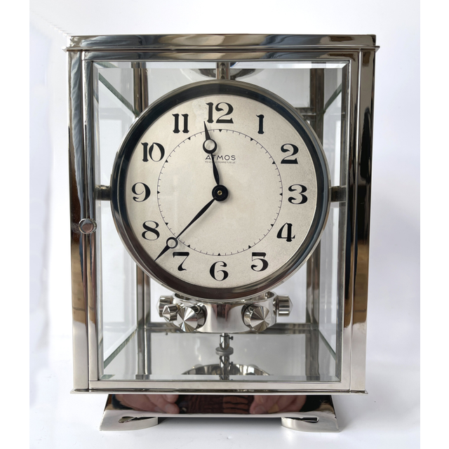 A nickel Atmos clock, J. L. Reutter, silvered dial, no. 8858, France ca. 1930.