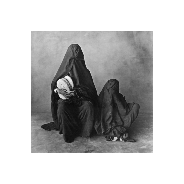Two women, wearing black, with bread, Morocco 1971